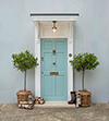 Door Bell Cover in Antiqued Brass with Ceramic Bell Push