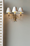 Triple Plantation Wall Light in Antiqued Brass