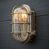 Bulkhead Outdoor Light in Antiqued Brass