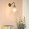 Ashley Fluted Wall Light with Carrick Arm in Antiqued Brass