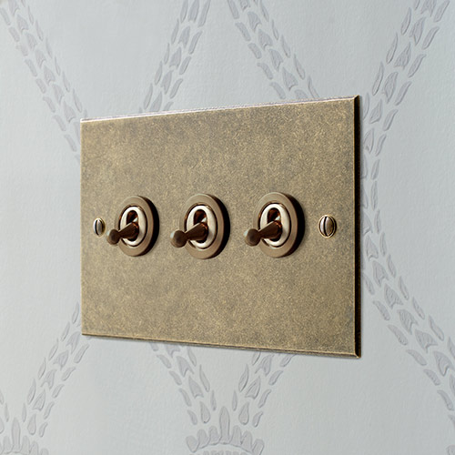 3 Gang Dolly Switch in Antiqued Brass